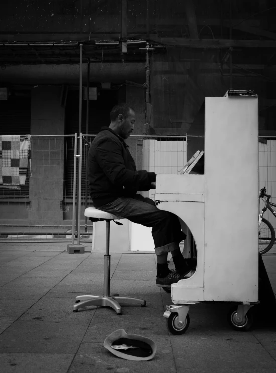 a black and white photo of a man playing a piano, an album cover, by Giovanni Pelliccioli, pexels contest winner, postminimalism, on the street, sittin, bum, blank