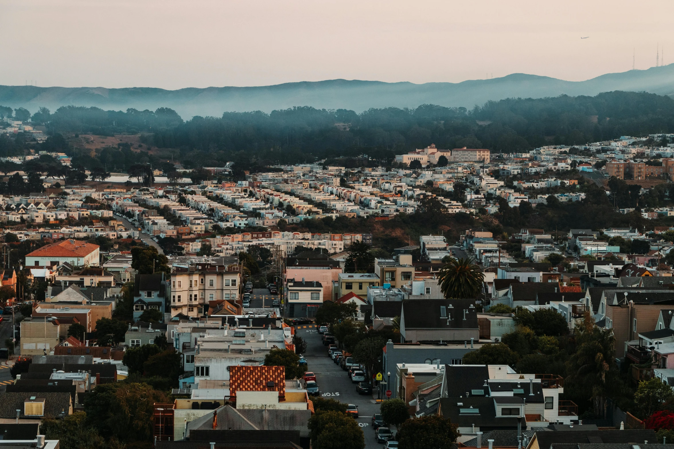 a view of a city from the top of a hill, by Carey Morris, pexels contest winner, bay area, late summer evening, suburbs, background image