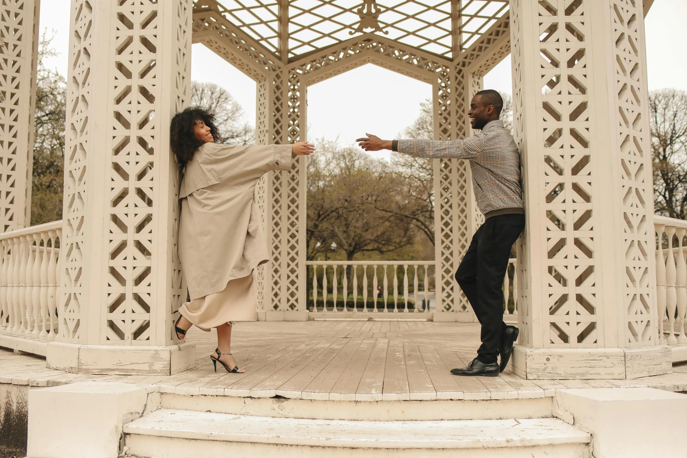 a man and woman dancing in a gazebo, by Lily Delissa Joseph, pexels contest winner, arabesque, grey, doing a sassy pose, jemal shabazz, brown