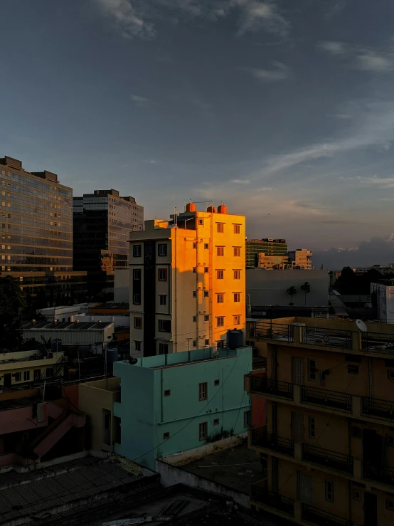 a very tall building sitting in the middle of a city, by Sven Erixson, golden hour photograph, puerto rico, bangalore, high quality image