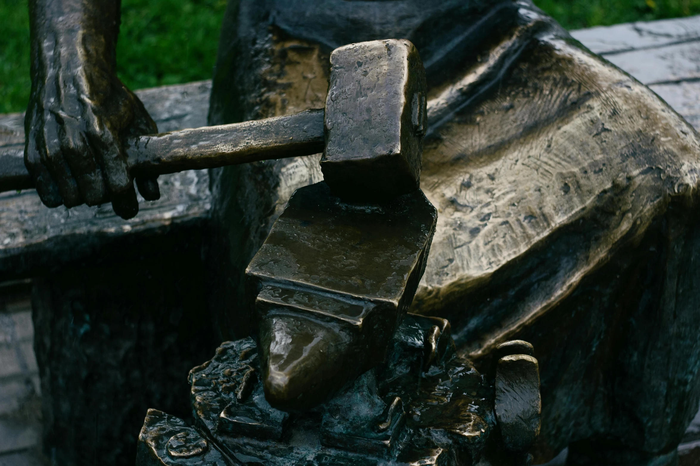 a statue of a man with a hammer in his hand, a bronze sculpture, by Henry Moore, pexels contest winner, process art, square jaw, bench, closeup - view, female dwarven blacksmith