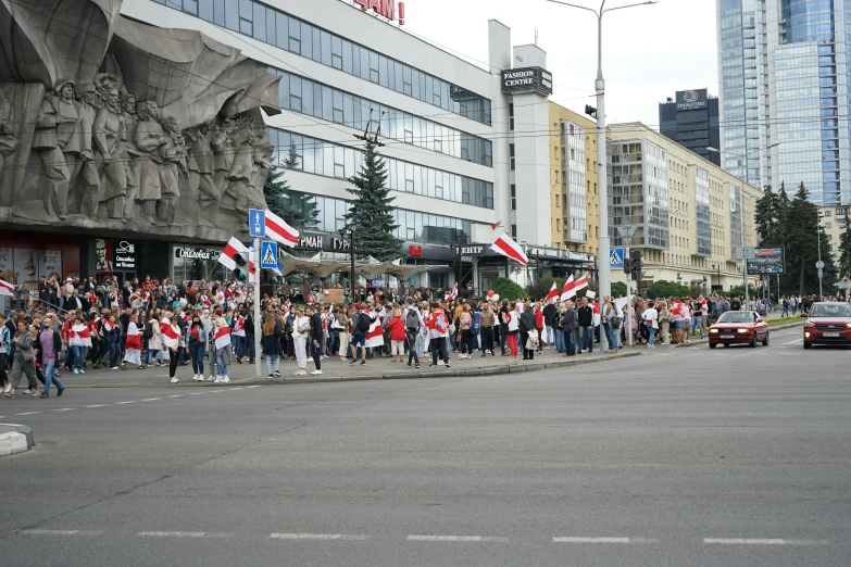 a group of people that are standing in the street, by Attila Meszlenyi, reddit, hurufiyya, patriotism, 15081959 21121991 01012000 4k, square, view from across the street