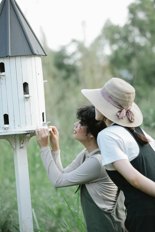 a couple of people standing next to a bird house, exploring, oyasumi punpun, on location, cottagecore