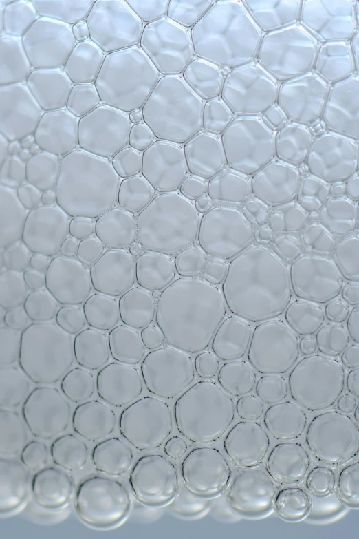 a close up of water bubbles on a surface, inspired by Richard Artschwager, satin silver, opaque glass, mechanically enhanced honeycomb, detailed product image