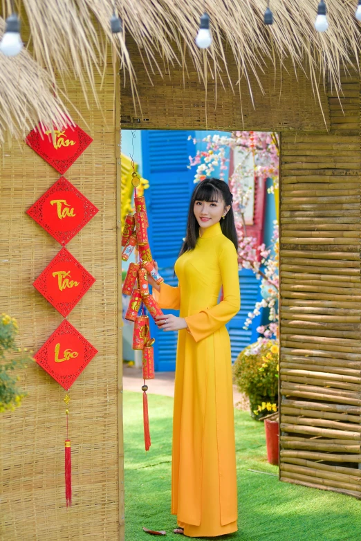 a woman in a yellow dress standing in a doorway, an album cover, inspired by Tan Ting-pho, ao dai, ( colorful ), holiday, tan