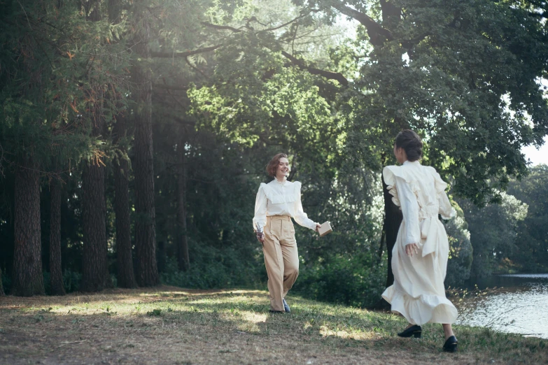 a couple of people that are standing in the grass, unsplash, renaissance, wearing white silk, walking through the trees, two women, wearing a linen shirt