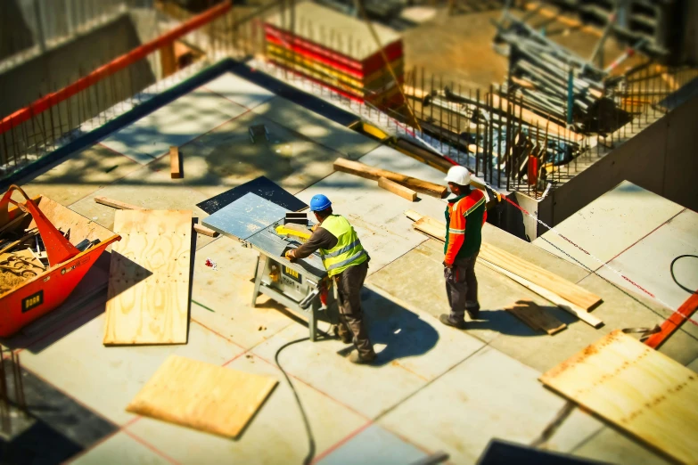 a couple of men standing on top of a construction site, pexels contest winner, constructivism, birdseye view, carpenter, working, no - text no - logo