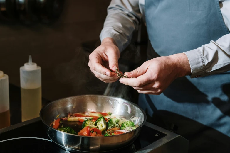 a close up of a person cooking food on a stove, hand holding a knife, profile image, bowl filled with food, fine dining