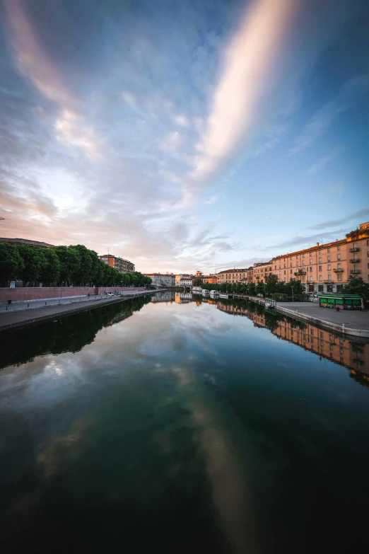 a river running through a city next to tall buildings, a picture, unsplash contest winner, renaissance, calm evening, eternal city, today\'s featured photograph 4k, summer morning light