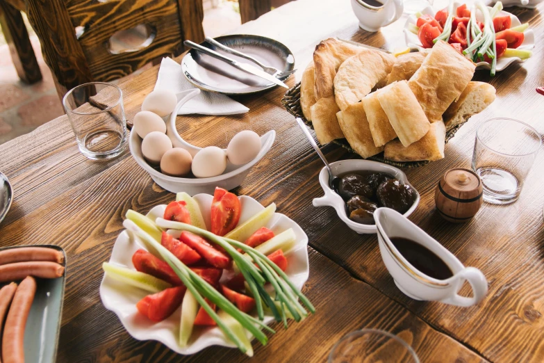 a wooden table topped with plates of food, unsplash, dau-al-set, hasbulla magomedov, breakfast, background image, taras susak