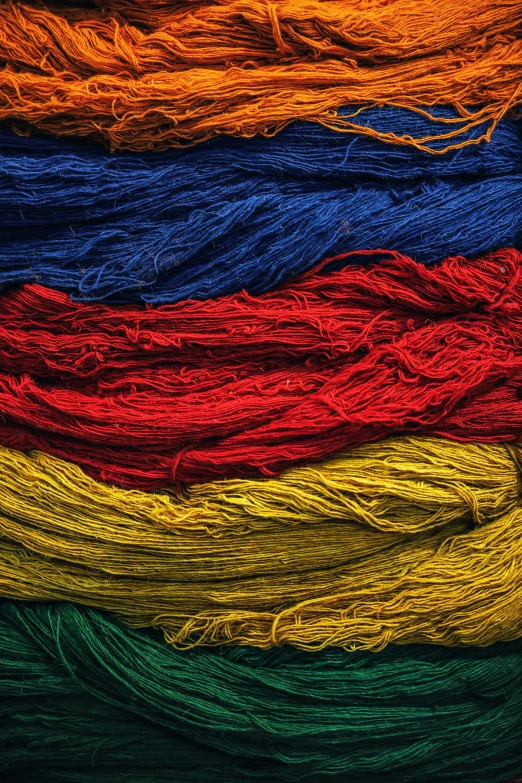 a pile of multicolored yarn sitting on top of each other, by Jessie Algie, color field, red yellow blue, colombian, color image, textile