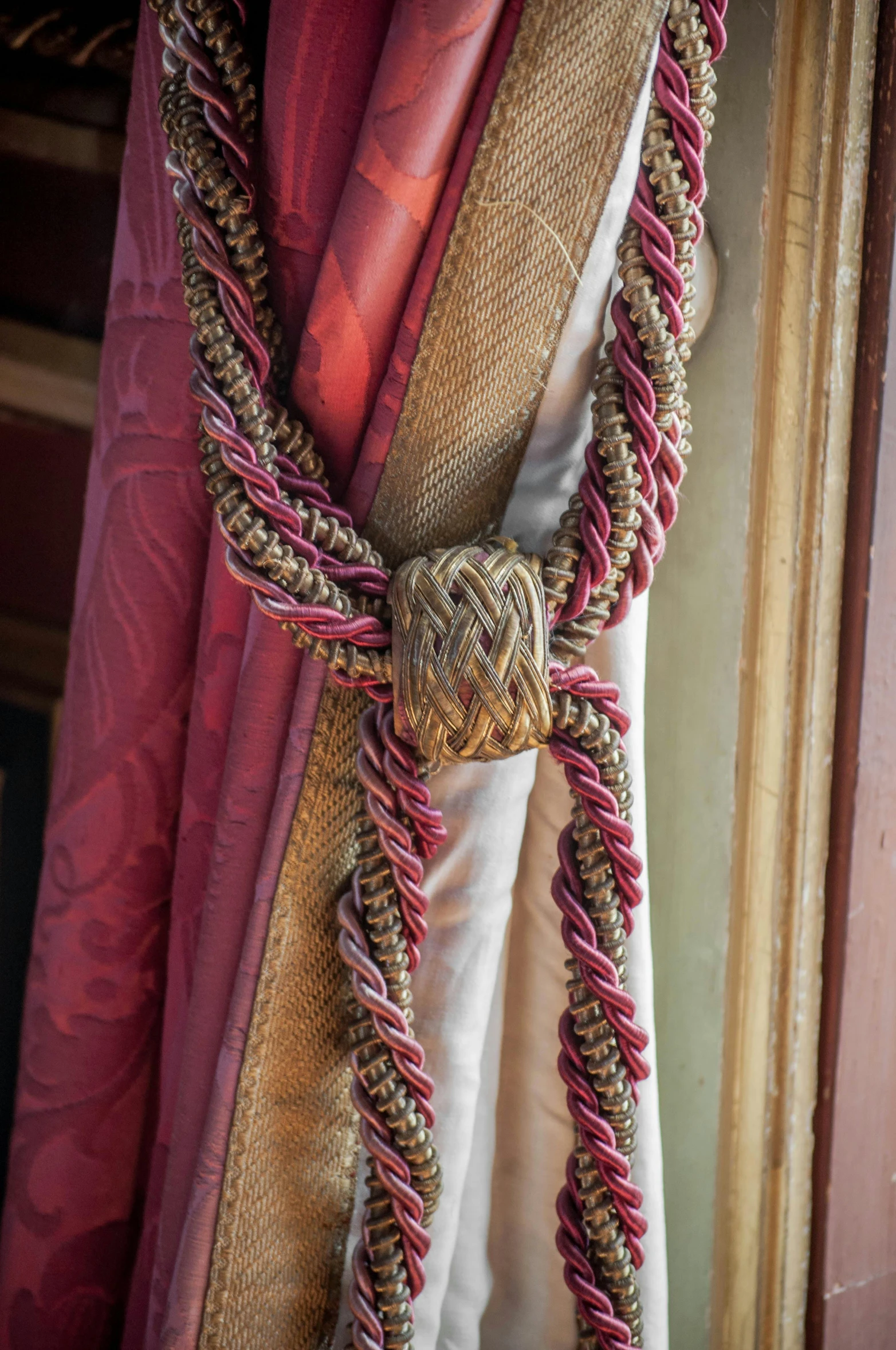 a close up of a curtain with a knot on it, renaissance, hot pink and gold color scheme, royal robe, rope, payne's grey and venetian red