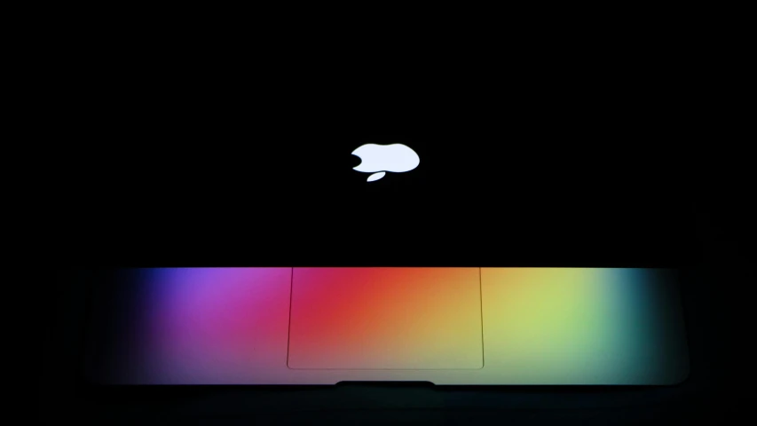 an apple laptop computer sitting on top of a table, by Jan Rustem, color field, gradient black to silver, random colors, apple logo, light mode