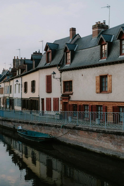 a row of buildings next to a body of water, a picture, by Raphaël Collin, canals, cozy and calm, french features, midwest town