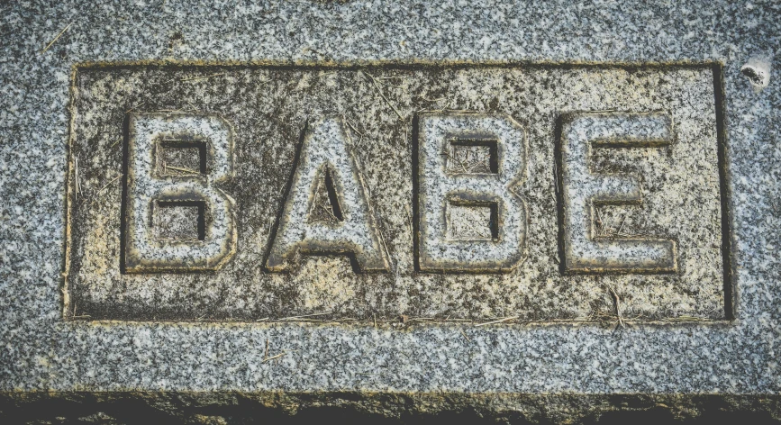 a stone with the word babe carved into it, an album cover, inspired by Gabriel Ba, pixabay, tomb, street signs, pregnancy, high texture detail