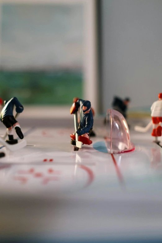 a group of figurines sitting on top of a table, shooting ice, zoomed in, let's play, concentration