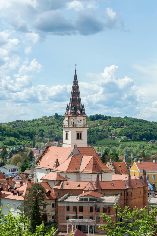 a view of a town from the top of a hill, inspired by Ernő Tibor, renaissance, orange roof, lead - covered spire, round, pink