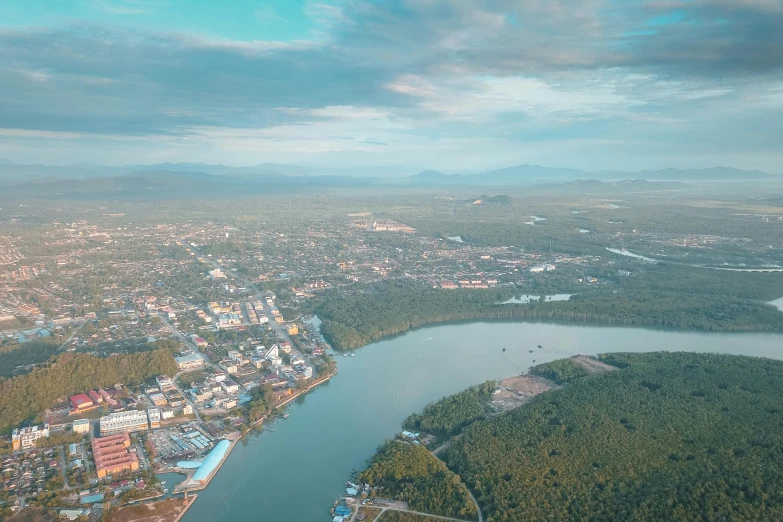 an aerial view of a city and a river, pexels contest winner, hurufiyya, river flow through borneo jungle, vray cinematic smooth, high quality print, 8k resolution”