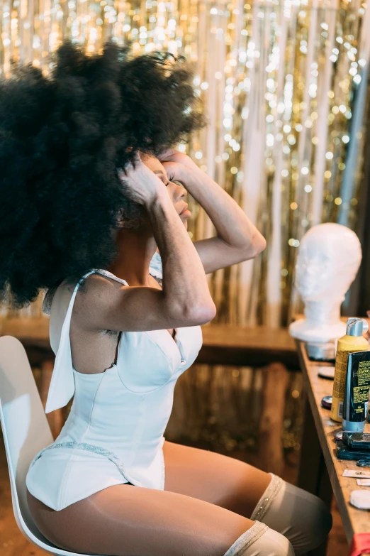 a woman sitting on a chair in front of a computer, pexels contest winner, afrofuturism, lush unkempt black hair, saturday night in a saloon, girl in white dress dancing, frizzy hair