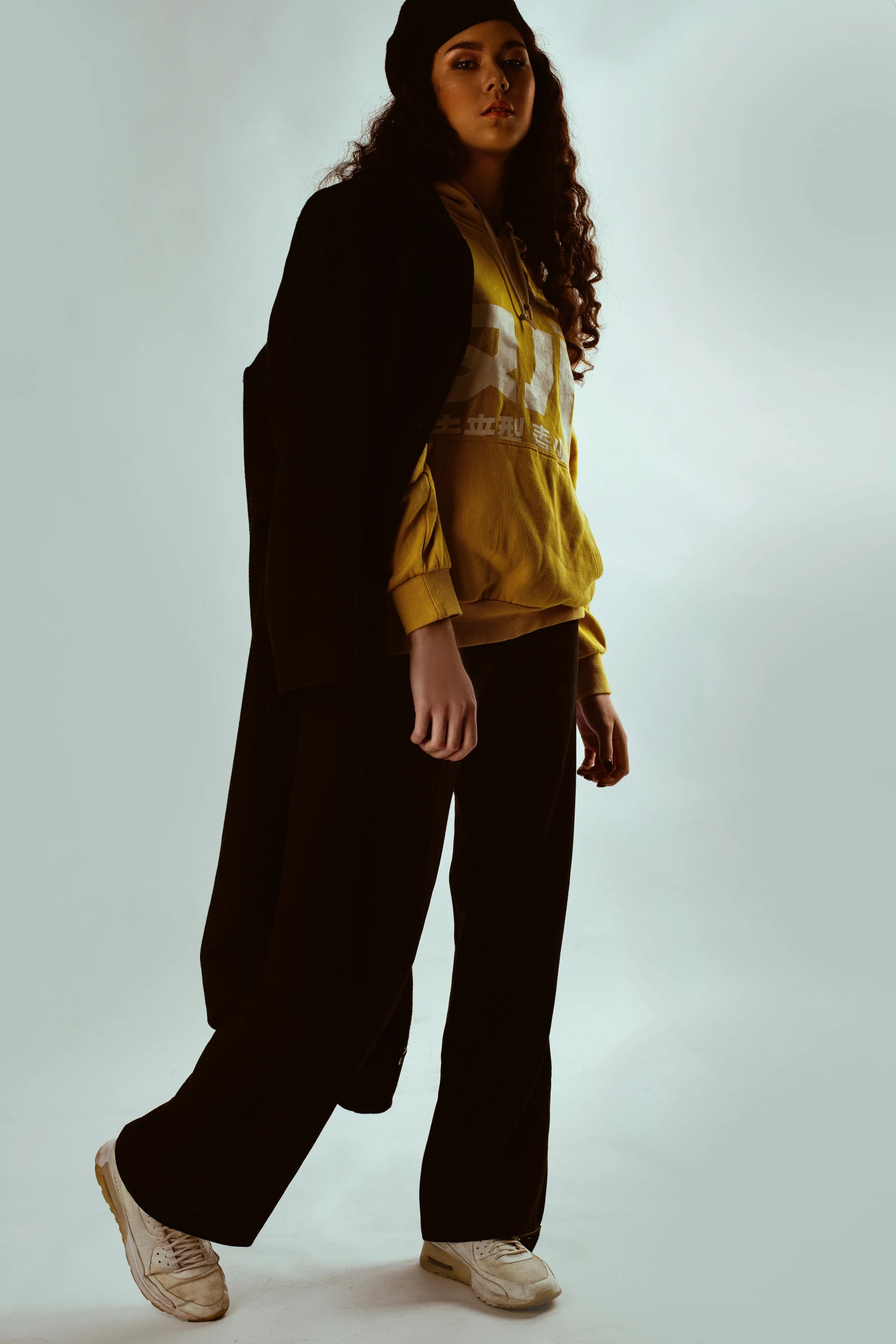 a woman in a yellow shirt and black pants, unsplash, wearing a worn out suit, young teen, ( low key light ), official store photo