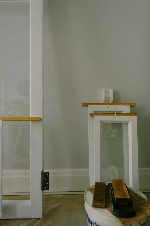 a picture of a room that is being remodeled, inspired by Leandro Erlich, light and space, lantern, white frame, close - up photograph, wooden supports