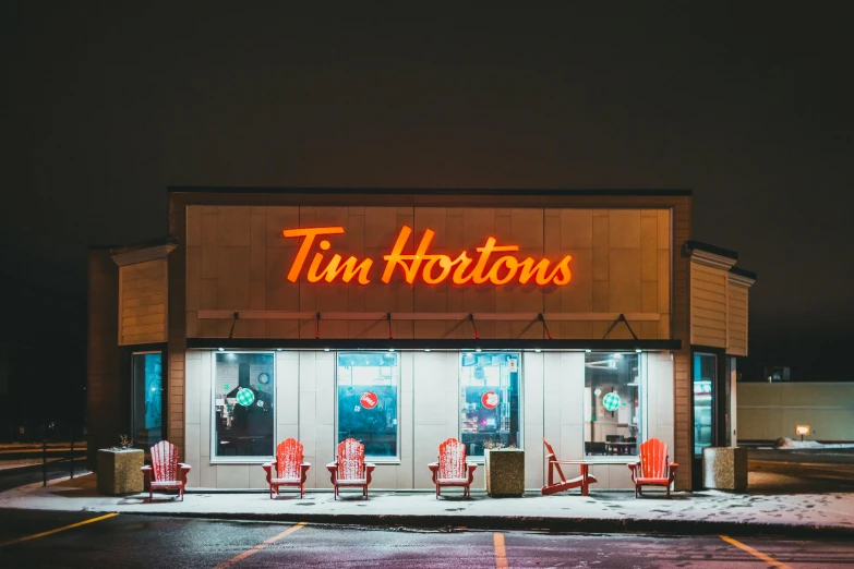 a group of red chairs sitting in front of a tim hortons store, by Tom Palin, trending on unsplash, tonalism, taverns nighttime lifestyle, thom browne, a photo of tom cruise, a multidimensional cozy tavern