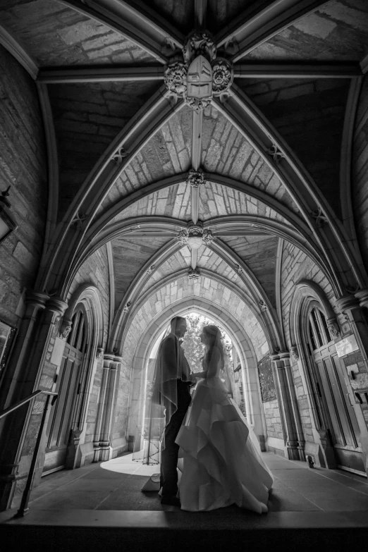 a black and white photo of a bride and groom, by Kev Walker, unsplash contest winner, international gothic, archs, wideangle, tone mapped, photograph ”