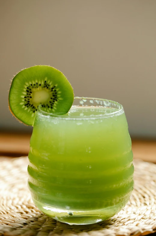 a kiwi drink is garnished with a slice of kiwi, inspired by Kanō Tan'yū, full body shot close up, cheery, misty