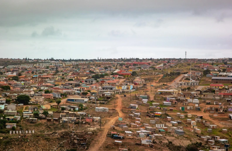 a view of a town from the top of a hill, by Daniel Lieske, dau-al-set, shanty town, cape, 2 0 2 2 photo, gray