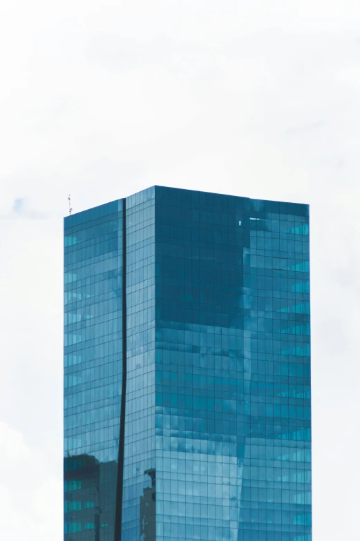 a very tall building sitting in the middle of a city, unsplash, minimalism, blue reflections, low quality photo, square, boston