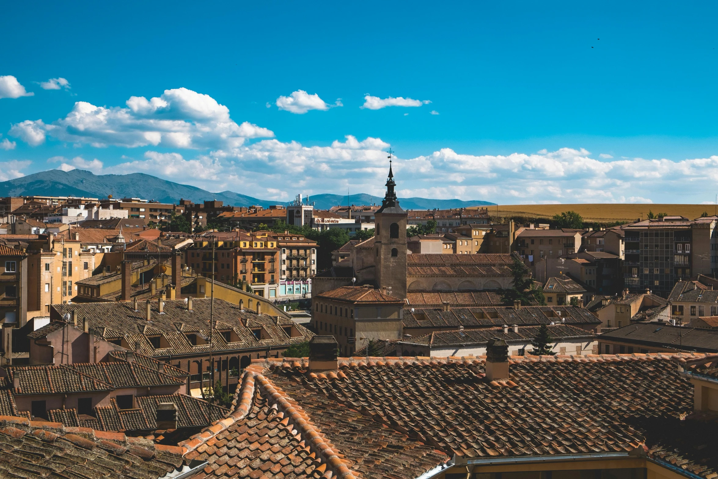 a view of a city from the top of a building, by Juan Giménez, pexels contest winner, baroque, village in the background, zurbaran, background image