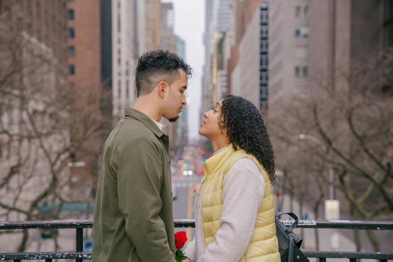 a man and woman standing next to each other on a bridge, pexels contest winner, in new york city, holding a rose, hispanic, gif