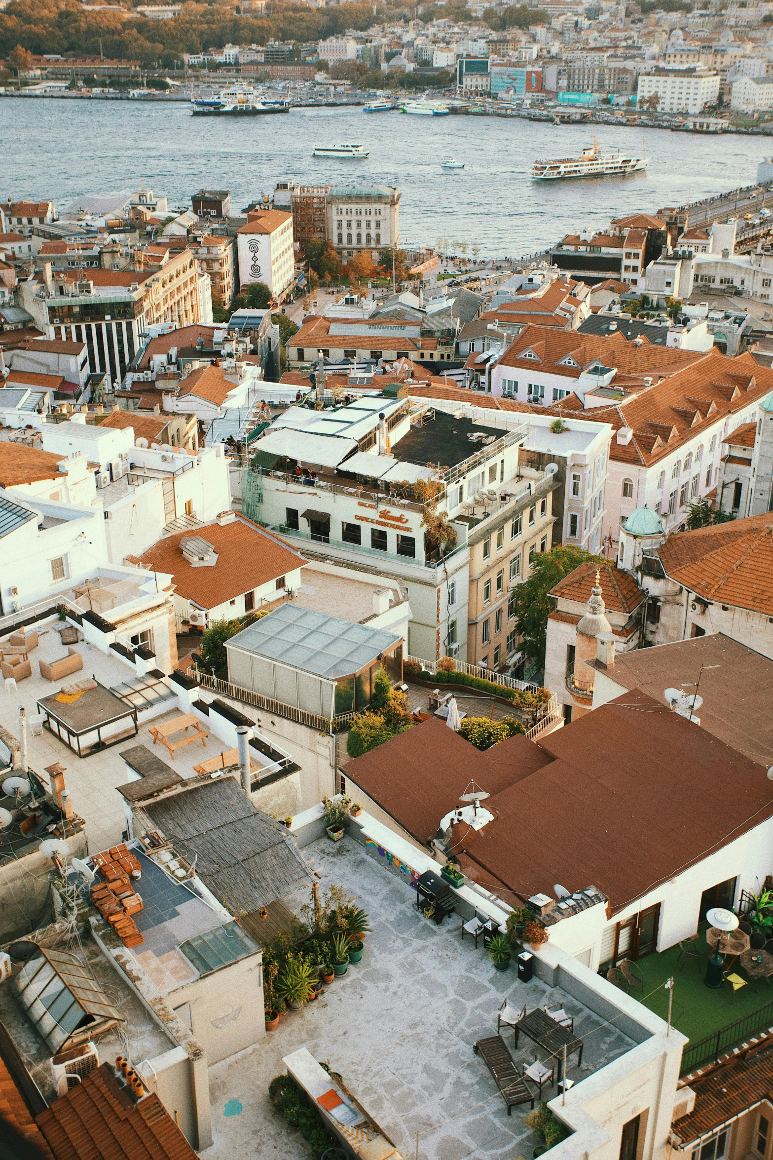 a view of a city from the top of a building, white buildings with red roofs, split near the left, flatlay, brown