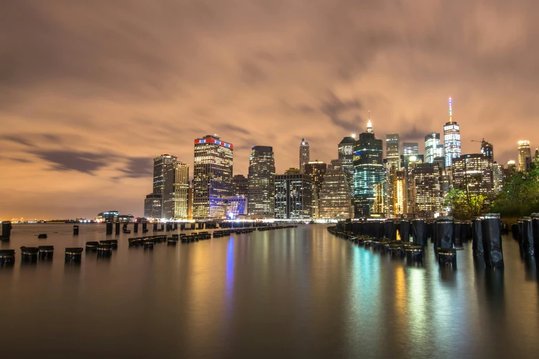 a large body of water with a city in the background, by Joseph Severn, pexels contest winner, nightlife, brooklyn, slide show, a colorful