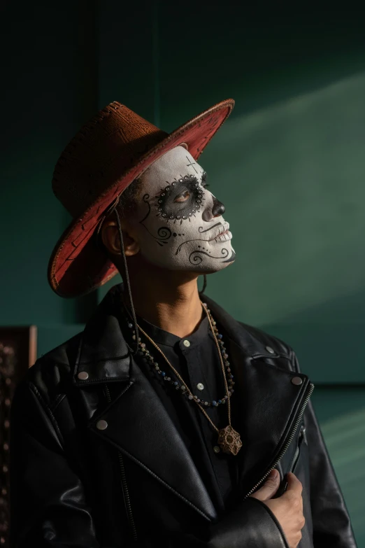 a man with a skeleton face painted on his face, an album cover, trending on pexels, sombrero, lgbtq, dark skinned, actor
