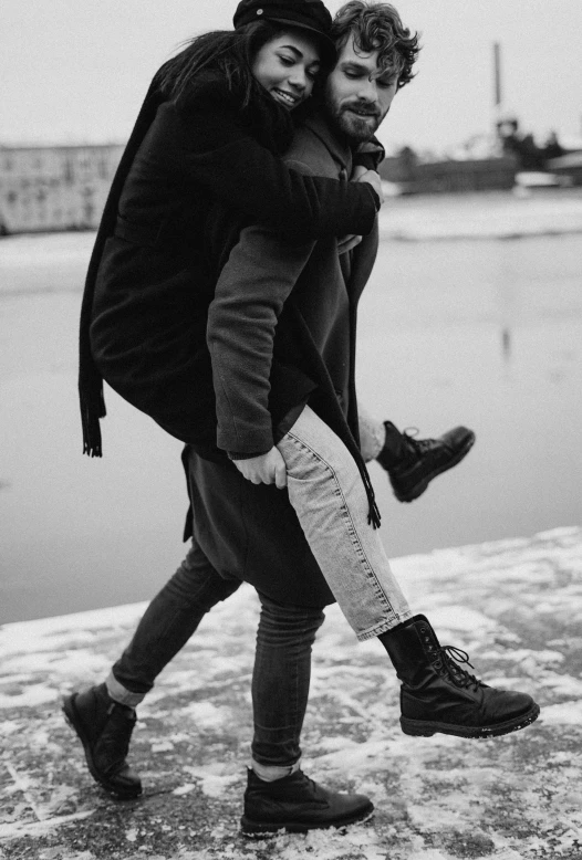 a man carrying a woman on his back, pexels contest winner, antipodeans, wearing black boots, winter time, black an white, non-binary