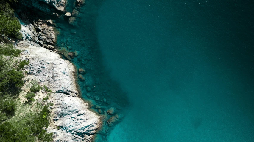 an aerial view of a body of water, inspired by Elsa Bleda, pexels contest winner, cinq terre, teal skin, rock pools, deep colour