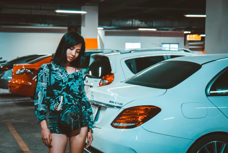 a woman standing in a parking garage next to parked cars, pexels contest winner, realism, asian girl, square, with beautiful exotic, short body