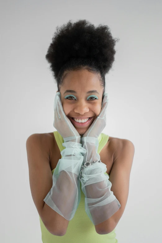 a close up of a person wearing gloves, by Lily Delissa Joseph, cg society contest winner, afrofuturism, playful smile, wearing organza gown, set against a white background, pale green glow