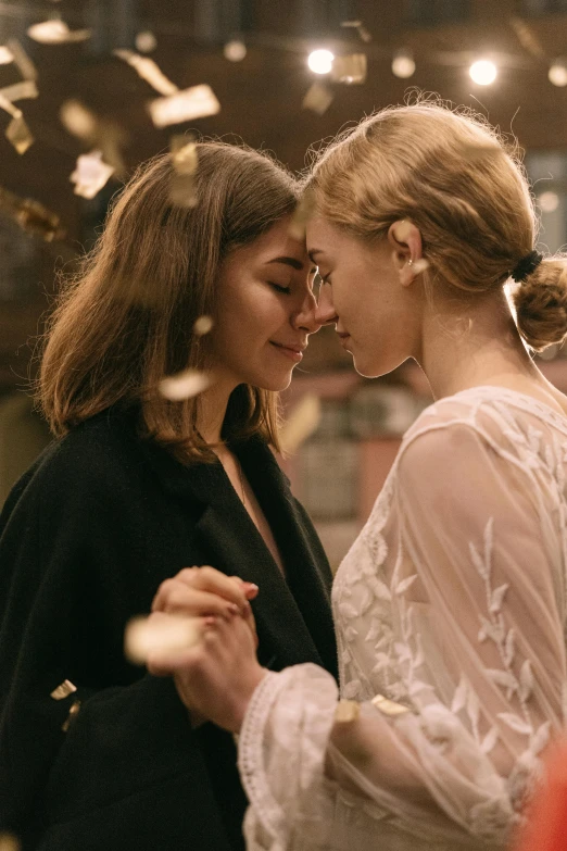 a couple of women standing next to each other, by Leila Faithfull, trending on pexels, romanticism, imogen poots, glittery wedding, romantic lead, orthodox