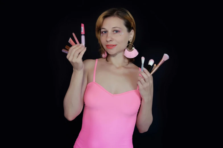 a woman in a pink dress holding up makeup brushes, avatar image, yulia nevskaya, low quality photo, thumbnail