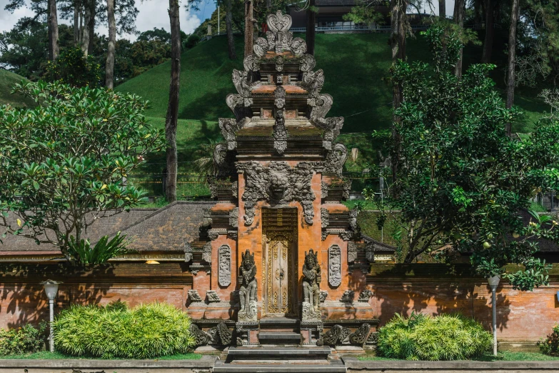 a statue sitting in the middle of a lush green field, doors, indonesia, avatar image, ornate tiled architecture