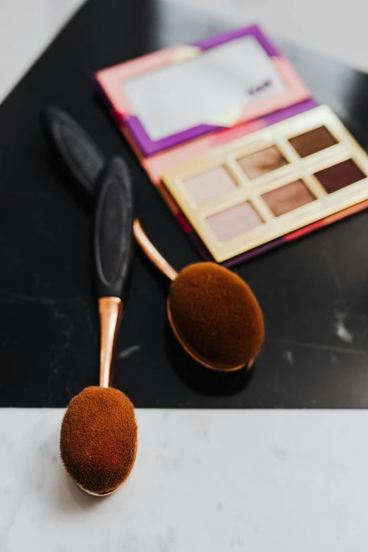 a couple of makeup brushes sitting on top of a table, an album cover, copper, sephora, smooth oval head, focus on full - body