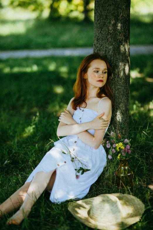 a woman in a white dress sitting under a tree, an album cover, inspired by Konstantin Somov, pexels contest winner, sadie sink, russian girlfriend, thoughtful ), high quality photo