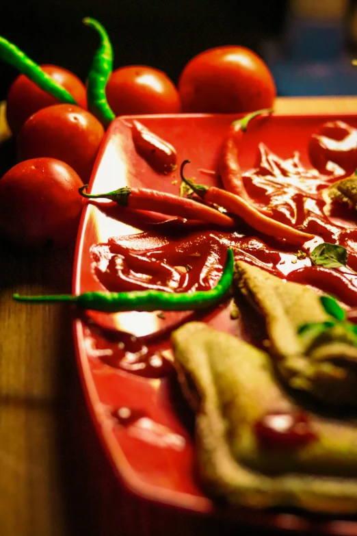 a close up of a plate of food on a table, by Julia Pishtar, bhut jolokia, red hoods, thumbnail, vibrant atmosphere