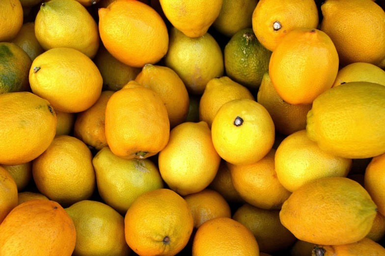 a pile of lemons sitting on top of each other, by Carey Morris, pexels, orange: 0.5, light glowy yellow eyes, performance, round-cropped