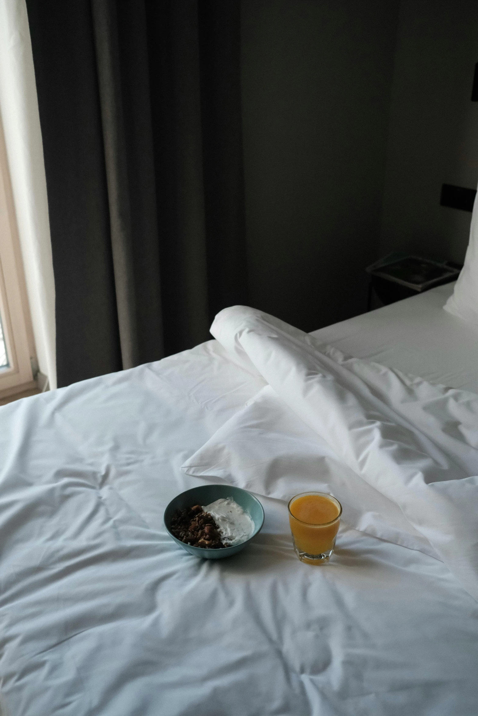 a plate of food sitting on top of a bed, by Mathias Kollros, drink, cold, grey, in barcelona