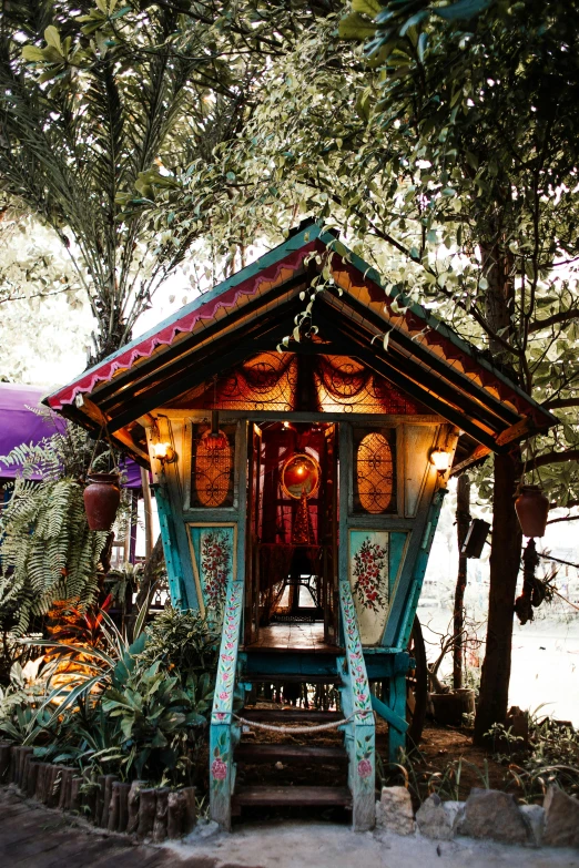 a small house sitting in the middle of a forest, unsplash, maximalism, neo - gypsy caravan, slide show, thai architecture, color image