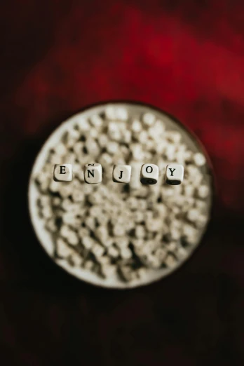 the word you are spelled in small letters on a red background, a picture, by Adam Marczyński, pexels contest winner, minimalism, 4k polymer clay food photography, silver，ivory, cubes, inside a glass jar