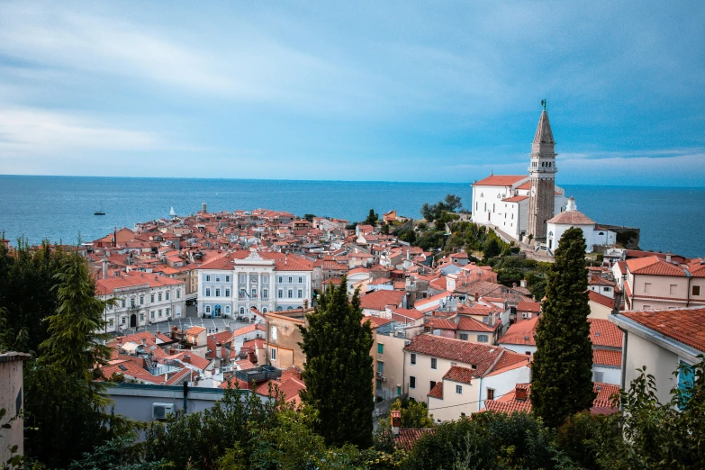 a view of a town from the top of a hill, by Matija Jama, pexels contest winner, croatian coastline, square, ravnica, foil